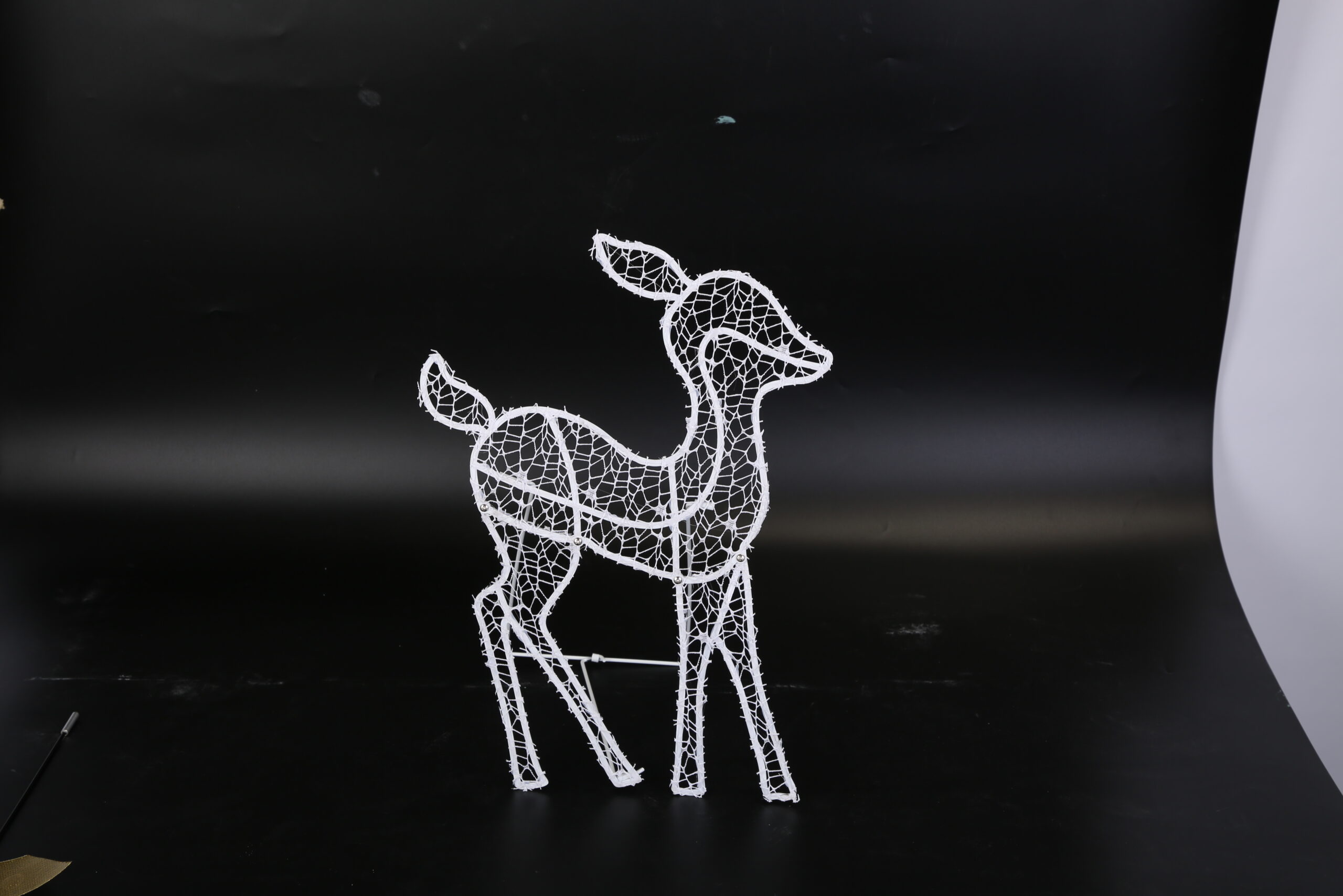 Three lighted reindeer figures forming a family yard display, view 4