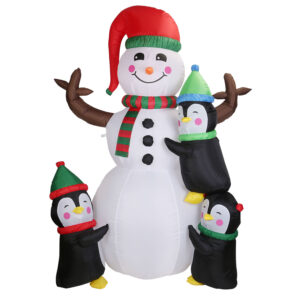 Inflatable snowman flanked by penguins, lit for the yard