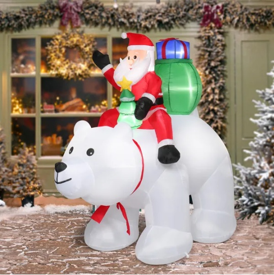 Inflatable Santa riding a polar bear, lit for a Christmas yard display, view 2