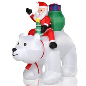 Inflatable Santa riding a polar bear, lit for a Christmas yard display