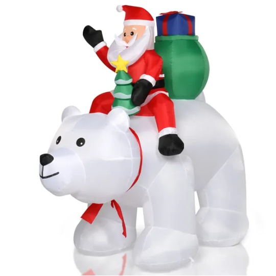 Inflatable Santa riding a polar bear, lit for a Christmas yard display