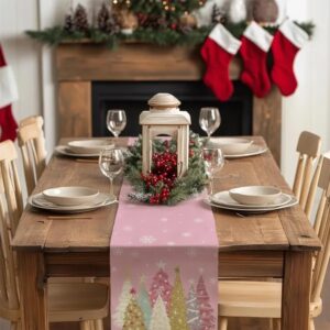 Pink Christmas table runner printed with trees and snowflakes