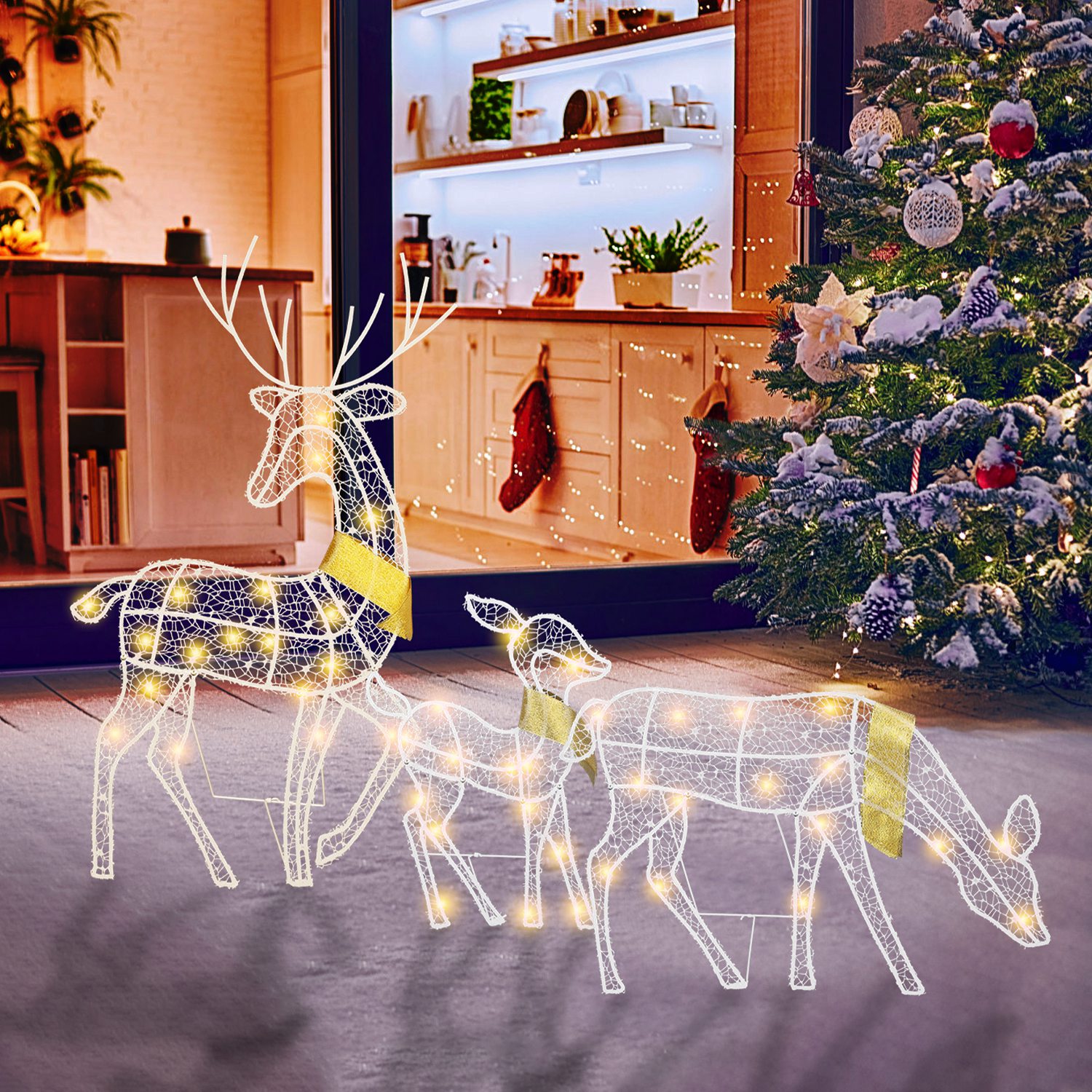 Three lighted reindeer figures forming a family yard display, view 8