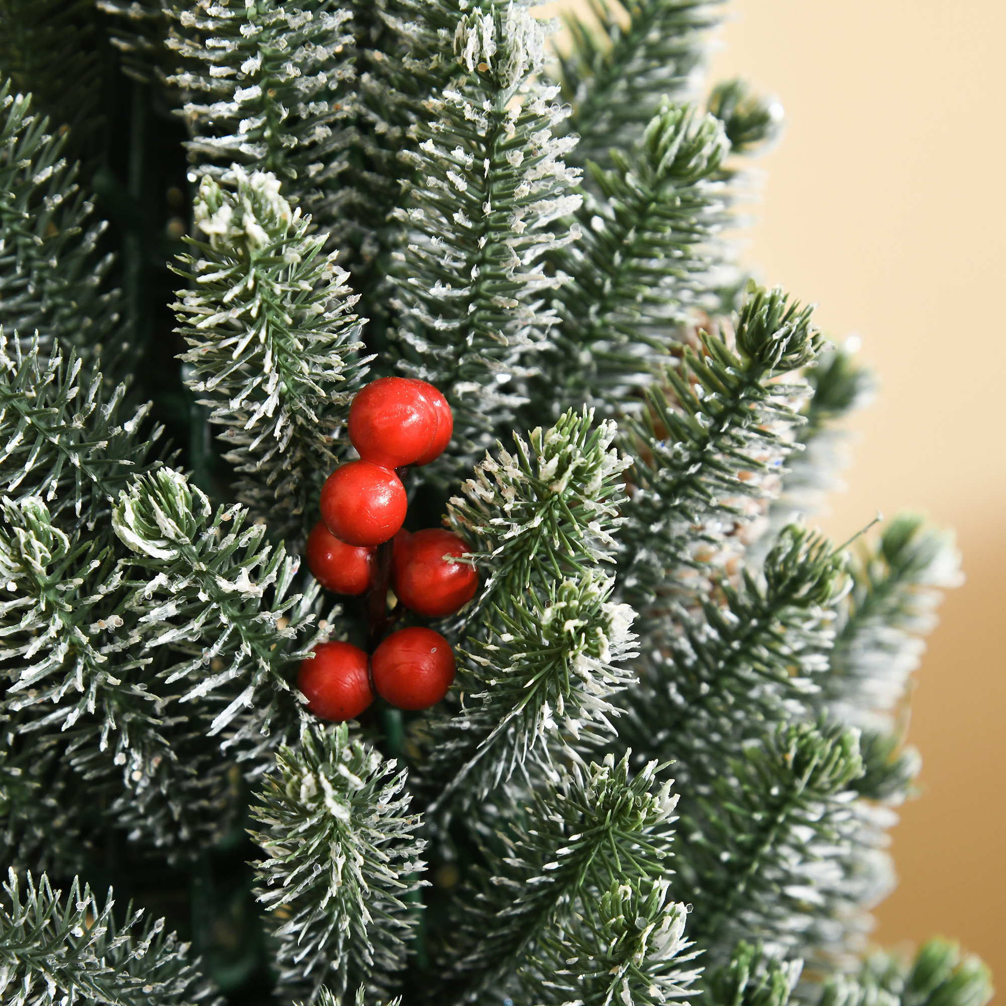 Flocked tabletop Christmas tree trimmed with pine cones and berries, view 3