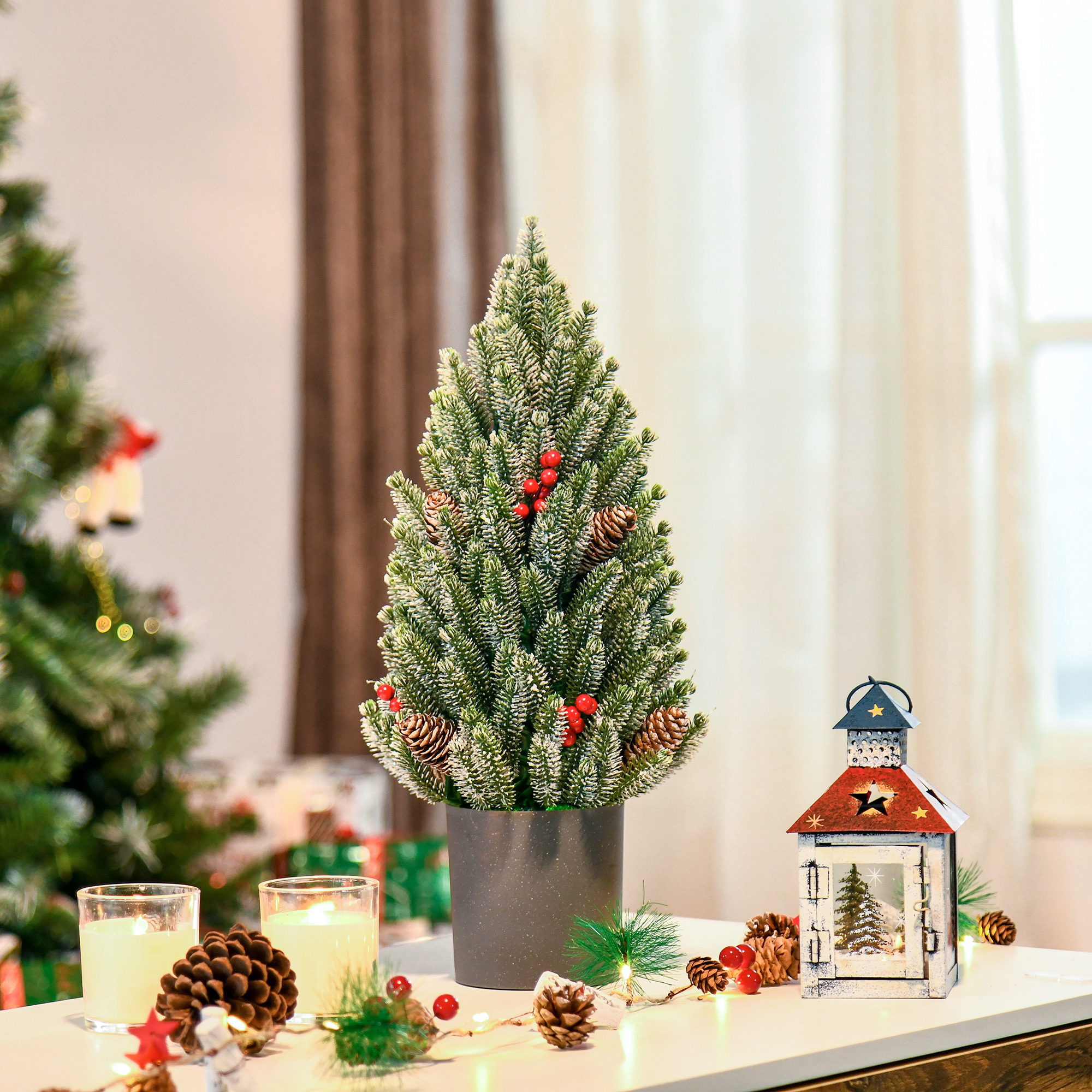 Flocked tabletop Christmas tree trimmed with pine cones and berries, view 2