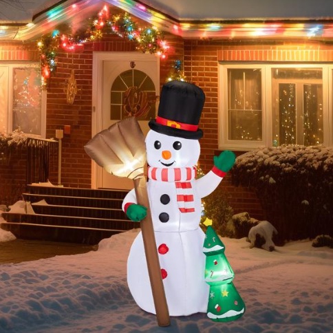 Inflatable snowman holding a broom beside a tree, lit from within