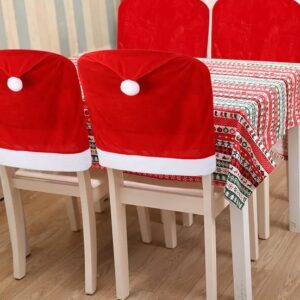 Santa hat chair back covers fitted to dining chairs at a set table