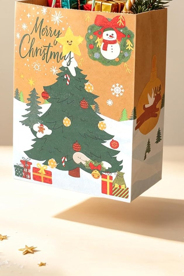 Single kraft Christmas gift bag with a printed tree and snowman design