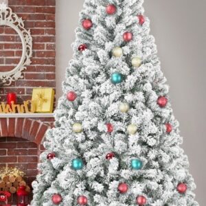 Snow flocked artificial Christmas tree decorated in a living room