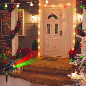Red and green laser projector light casting dots across a decorated house entrance