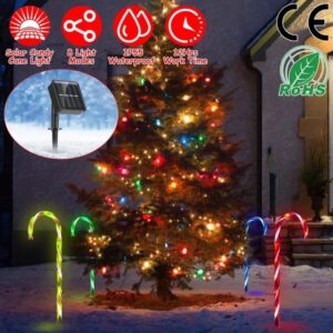 Solar candy cane pathway lights lighting a garden path beside a Christmas tree