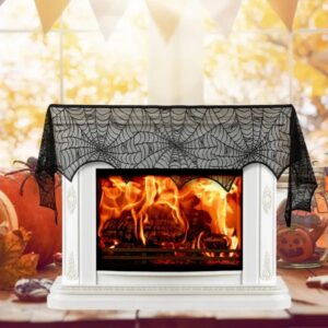 Black lace spiderweb scarf draped over a white fireplace mantel
